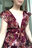Colour is a bit more purply than the stock photos. Still lovely, there are little grips sewn in on the shoulders which is helpful since I imagine they could slip. Unfortunately the bust was too loose on me. There is a tie at the back which helps the fit but I felt too much gaping in the fabric at the top. - Erin G.
