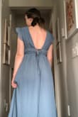 There are little grips sewn in on the shoulders which is helpful since I imagine they could slip. Unfortunately the bust was too loose on me. There is a tie at the back which helps the fit but I felt too much gaping in the fabric at the top.
The fabric is true in colour and the bodice is SO pretty (front and back), will probably exchange for a size smaller since the hips and waist are loose fitting :) - Erin G.