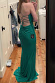 It fits true to size, and it's also adjustable because of the back. The material is very nice. It's a very flattering dress! In the picture, it looks more teal, but in person, it's more green. - Mikyla H.