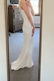 This dress is long but can easily be hemmed. I like that at my height, it kind of creates a small train. It has a snug fit but is still comfortable. The straps are adjustable but it made it look a little cheap. So I plan to alter the straps and take the adjustable piece out. I got the dress so I could take honeymoon photos in it on vacation. - Julie G.