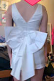 So cute! I bought it for my reception dress for my wedding. It's a bit tight around my midsection but fits everywhere else. With shapewear, it will be fine! The material is nice and thick just a little wrinkly. - Victoria B.