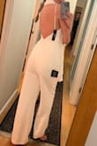 Material is nice and thick, not see-through whatsoever, the low back is beautiful. The top doesn't leave a ton of support so you may need some sort of bra if you're busty. Also, the straps are not super supportive but will do fine if you don't need a ton of support. I bought this for my casual rehearsal dinner and will wear it with a white scarf. I'm 5'10 and the jumpsuit just touches the ground, I planned to wear flats anyways so it works. Very comfy and a great find for the price. - Lindsay P.