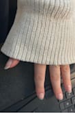 Super cozy and soft material. Sleeves are bell sleeves so they do get in my way slightly when trying to accomplish some tasks around the house so definitely consider this a sweater to lounge around the house in and chill. I got a medium (am usually either a medium or a large) and this is slightly oversized so fits great. - Kelly L.