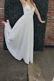 Bought this beautiful gown for my daughter's sorority presentation. I bought seven different white gowns in total from five different companies, but this one was the best. So glad it worked as it was a final sale purchase. My daughter wore it with 3-inch sandals, and at 5'7" the gown just skimmed the ground. It really needed about a 1/2-inch alteration but with a small platform on the shoe, it would have been perfect.  It has a nice slimming fit and the material doesn't wrinkle much. It looked lovely. - Anita N.