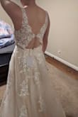 Beautiful dress, simple and right amount of lace. I love that it doesn't have a long train. If you have a longer torso, the back will fit you better than me. I did return it but I recommend it for others! - Kacie Y.
