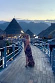 Wore this on our trip to Tahiti and received many compliments. The dress was a little long and I am 5'9 but I chose to wear flats still. I did need to pick it up at times so I wouldn't step on it while walking. Dress is open back so you can't wear a bra but you can tie it tighter around the neck which helps. Loved this dress. - Vanessa S.