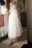 Got this dress for my bridal shower and I absolutely love the fit and feel! It's gorgeous and the material is great albeit a little itchy on the bust. Had to dock off one point for the zipper though, it keeps getting stuck. Paired it with a tulle bow veil to complete the look! - Ashley D.