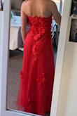 Absolutely love this dress and the color. I am wearing it for my senior prom and couldn't be happier with it, especially buying it online but it fits great. I did order a small just because it's strapless I wanted to make sure it would stay up and it does! It's a little big around my waist for my liking but the little space makes it comfortable. The zipper in the back is covered and hidden by the flowers -which are so cute and lay very nicely. (I couldn't zip it up all the way by myself because my arms don't bend like that but it is able to zip all the way!!!) - Gracie S.