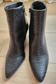 Honest Review:

Super cute snake print booties.
Purchased (Size 7) these for my son's western theme birthday party because they go well with my outfit. Fits true to size. However, they definitely need to worn out or something because they crease & are uncomfortable without ankle-high socks. They rub up on the front of my ankle. However, for the price & look I will be keeping them. - Kimberly G.