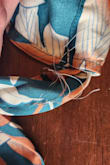 I loved this dress, the fit, and pattern are BEAUTIFUL but when I pulled it out of the packaging I immediately noticed fraying threads ..... see pictures. I will be requesting an exchange and hope the next one is not damaged. - Mindy K.