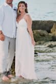 I wore this for my 10-year vow renewal in the Bahamas. Ordered an XS based on people with my similar build (5'2, 34D bust, and pretty curvy in my hips/butt). I didn't get it taken in because I knew we'd be on the beach. It flowed perfectly and fit amazing! It was a bit sheer on the bust so I recommend pasties/nipple covers if getting white. Loved the high/low cut and the slit in the front. It's pretty long, so if I were at any other event I would probably get it hemmed a bit in the back. - Vanessa B.