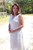 I'm usually a medium in shirts and size 6 jeans. I ordered the medium dress first and It was too snug around the ribs and hard to zip. The exchange for the large was quick and super easy. Large fit me perfectly. The dress is exceptionally made. Has an inner lining built in so you can choose to wear a bra or not. The color is listed as white, it is not a bright white. It looks better with pearls than a sparkling stone. I felt great in my dress and had many compliments! - Catherine F.