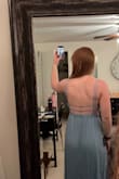 Bought this as a bridesmaid dress. I was torn between ordering a small or medium, ended up going with a medium and I'm glad I did. 
The back straps aren't adjustable, I don't think I have large/wide back/lats but the horizontal straps are a bit snug. 
The front is stitched oddly as pointed out in the picture. I plan to snip the one stitch to see how it lays naturally and resew if need be. 
Overall I'm happy with it! - Henry D.
