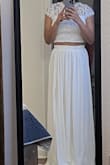 I love this piece. I'm 5'2". 110 lbs. Inverted triangle body shape. I chose S. The skirt is too long for me so I will have to tailor it. Fits nicely around the waist. The shirt fits like a glove. - Mariella H.
