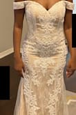 This dress is absolutely beautiful. It fit nearly perfectly, only a tad snug. Size up if you're in between sizes. It has a light tan/dark beige color underneath. The silhouette and craftsmanship is wonderful. This wasn't the dress for me since I didn't like the no-shoulder look, but it's still beautiful. - Paige N.