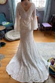 I had a wedding dress that I paid a lot more for and regretted after purchasing. I bought this in hopes that I would be able to save money and find something I liked better and it's perfect! It fits me perfectly in the body - the cup size needs to be brought in a bit but it's otherwise perfect! Great quality, beautiful train, thick material but still comfortable! Im so excited to wear this for my October wedding! I wish I had just found this first! - Catherine C.