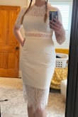 I really love the style of this dress, and the lace is beautiful. However I ordered a medium and a large and neither is right on me. I'm a solid size 8 jeans across most brands but carry my weight in the middle. The medium is so tight throughout the entire dress I couldn't lift my arms even up to shoulder height. The large is way more comfortable but manages to look too big especially up top. I'm going to play with some shapewear and see if I can get one to work, though, I love the dress so much.

Note, the lace pattern is gorgeous but also isn't uniform so the top might look different from the picture. The large I got has the vertical part of the pattern at the top of the dress (see photos). - Erin W.