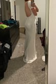 I should have ordered a medium and it might have been more flattering although the small fit. Really didn't like the sleeves and am not a big fan of the middle front slit. Thought the back was nice though. - Amy A.