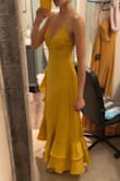 I'm usually not into ruffles or satin fabric, but I tried this on and knew I had to have it! The back is so flattering, and the dress is comfortable and flowy and will make you want to dance! It's an eye-catcher and bound to get you compliments. You'll probably need some help tightening the ties in the back, and the left chest area did tend to flip over to reveal the lining, but I was able to fix that with some fashion tape. - Anita D.