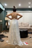 This dress is stunning! Pictures don't have great lighting but it's so sparkly and beautiful. I was so hesitant to buy on here and I don't regret it. I am still trying to figure out the straps and how they cross but it's so beautiful regardless. The item came in a box all folded up and I was so worried it would be wrinkled and it was perfect and had zero signs of being folded. Plus a free garment bag is a MAJOR plus! Will definitely be recommending and buying more items!! - Meghan S.