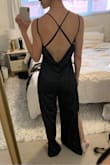 Cowl neck AND back, strappy open back, jumpsuit with leg slits, luxurious silky black fabric... what more could you want?! (*ahem! pockets!*)

Unfortunately, the fit was pretty bad on me. The cowl neck was too low-cut, so instead of giving a flattering illusion like most cowls do, there was no hiding my lack of cleavage...especially if I leaned forward to any degree, giving a clear view of my ENTIRE torso down to my navel. No amount of double sided sticky tape was going to cut it. 

The sliding straps cut in to my shoulders a bit while somehow still feeling unsecured. The fit through the waist/hips was funny, gave my butt a whole new shape that I wasn't loving. And, as you can see in the first photo, the legs would have needed to be hemmed even with 3" heels. Darn :( - Alexandra H.