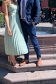 I bought this dress for a formal wedding in Mexico in sage green, and I was a little hesitant, mainly because I didn't have much of a tan. I ordered a small, and with a bit of strap adjustment, it fit perfectly. I have a small bust, so I used silicone cups which I ended up taking out by the end of the night. I would recommend fabric tape, which will help keep everything intact more. The detail and pleats on the dress elevated the formality, and I had fun dancing all night in it! I got so many compliments! - Abigail L.