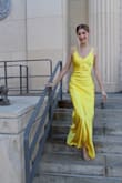 My daughter felt beautiful in this dress! It fit her perfectly, and she received many compliments. It doesn't photograph well with flash, so I think a softer yellow and less shiny fabric would be better. A show-stopper for sure though! - Julie L.