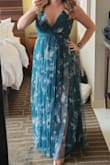 I love this dress! I wore it to a wedding and got so many compliments on it! I got a size small and it was a little tight in the waist but not unbearable. I'm smaller chested so I feel like if I had sized up to a medium it would be been way too big in the bust, so I'm glad I went with a small. I did have to hem it but that's no surprise since I am pretty short. The color is gorgeous! The slits do go up pretty high but the tulle overlay helps to give you that sense of coverage while still being very sexy! - Georgeann V.