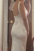 I was unsure about buying this dress since it didn't have any reviews, but I still went for it. It's beautiful and fits just right and shows off my curves. I am short so it's pretty long on me, I would need to get it hemmed. Also has a beautiful train. it's a bit snug on my tummy, but shape wear can help with that. Overall it's beautiful and a classic dress. - Ashley A.