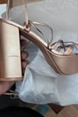 The shoes are ok but they arrived scratched up. They're a little too tall for me (I'm 5'2) but they are still cute. I don't know if I will wear them to the wedding. - Liz D.