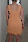 This dress is very flattering and fits great on my body type. Like the other reviews said it runs small so I ordered a size larger. It's still a little snug so I'm hoping it doesn't shrink in the wash. The dress is lined and the quality is great. The tassels are so fun and I'm excited to wear this on vacation! - Marissa B.