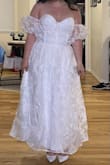 I loved how the model looked in this dress, and I knew I needed it for my bridal shower in two weeks. I ordered the medium because the size chart AND the size calculator both indicated I would definitely be a medium. Well, that was wrong and it barely zipped. So in a panic, I reordered a large one once it restocked. It came today and it is now a little too big on me. I still love the dress and my fiancé teared up when he saw me wear it, so I'm going to make it work for my bridal shower. Just wish the size chart was more accurate or that this was offered in more specific number sizes. Also, the outer layer fabric does feel a little cheap, and I don't think this dress is worth $94, maybe closer to $50? - Victoria W.