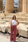 For someone who doesn't like wearing shorts, these flowy comfortable pants are just perfect to pack on your next vacation! I wore them all day touring around Greece, paired with a white pair of puma sneakers. I did take them to be hemmed about 5 inches to be able to wear with flats, as I am a shortie! Outfit also looks super cute with a pair of wedges. Very versatile! I'm usually a small/medium (I have a big butt and thighs). I ordered the medium, but a small would probably work too since they are stretchy. Definitely will be ordering the black pair as well :) - Ashlee K.