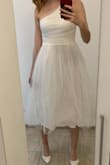 I bought this dress for my wedding like a dress to change after midnight, but I am sending it back right after trying it on. The tulle skirt has no form (maybe it would have if I ironed it), it looks unflattering, and it moves differently from the skirt under it. But the biggest minus is that the material is extremely itchy and very uncomfortable, I couldn´t stand being in it for 5 minutes, I think it´s because there is the tulle material also on the inside somehow. The only star is that the XS size was true to size for me. - Bianka B.