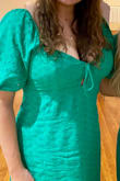 Daughter wanted white for graduation and green for another event. The dress is really cute with the puff sleeves and eyelet embroidery. Well lined, as she wore black nike pros under the white dress. Size XL was a more comfortable fit as L was slightly snug. Cleavage was definitely showing, she didn't mind, but something to consider. She received many compliments on both colors! - Melina H.