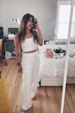 I have learned that lulus pants run too long for anybody who is short. I'm 5'2 and I always have to cut off like 4-5 inches off the pants. 

I also didn't like the strap on me for some reason so I cut it off. 

Got so many compliments about this outfit. - Ana H.