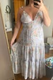 This dress has stretch in the back, as well as tie straps that make it adjustable. The lavender print is beautiful! Planning to wear to my best friends bridal shower. One of the buttons popped off as I was pulling it over my hips, so be careful. It's very delicate! I have a smaller bust and this makes me feel very confident. - Marina N.