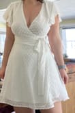 I wore this dress for graduation and it fit great! I was surprised by the quality. Even though it was white the fabric was thick enough to not be see through. I would recommend fashion tape or a pin for the top... the dress stayed covering me the whole day but was a little too low cut for me unless tied very tight. - Sarah S.