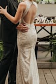 This dress was beautiful! I used it as my reception dress for my wedding. It was lightweight and stretchy, perfect for eating tacos and dancing. The XS was good but it would have been perfect if I could get an XXS. I have a pretty small ribcage so I had to get it taken in on the sides and around the neck but my tailor had no issues. I also had her put in a bustle and I forgot to unbustle it so I didn't get any pics of the train but it was beautiful! The only thing I thought was strange is that the slit goes right up the middle? But it ended up letting in a nice breeze while I was dancing. It was a very nice dress for the price and I'm glad I got it! - Marna M.