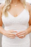 It fit perfectly right out of the box! It's very comfortable. The beading is so pretty and makes the dress look very elegant. The fit is very flattering and slimming. - Jessica M.