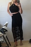 Love this set so much but it didn't fit me right! I'm a 32 double or triple-D and the top felt a little loose and offered no support. The skirt's elastic didn't cause bulging but it felt super tight and uncomfortable around my waist. It's like I need one size smaller in the top and one size larger in the bottom. If they were sold separately I'd definitely repurchase! Like others said, the fabric is nice and stretchy but does leave little black pieces of lint everywhere. I didn't find the fabric to be especially hot or heavy, which is a plus. - Georgia K.