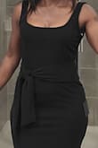 The material is stretchy and soft. This dress is sexy and can be dressed up with heels or down with sandals or tennis shoes. I'm going to purchase the taupe color as well. - Shieta M.