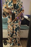 The jumpsuit looks okay, as I'm not used to print. My husband liked it, so I kept it. Fits loose up top. It is very long, I taped it up about 2.5 inches. Not happy about the odd tiny clear button in the back that is supposed to fit into a very tiny lope. No one can get this on without assistance, which is why I left off 2 stars. The back is a cheaply made design flaw. Definitely have to pay to get alterations. - Annette G.