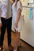 I bought this to wear for graduation and I am so happy I did! The length was perfect and the cutout really made it different. The material doesn't really stretch but it was still comfortable to wear even after dinner with my family. Overall super happy with this dress! - Kennedy B.