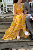 This dress is long. I'm 5'9 and it still almost hit the floor with clogs on. I'd recommend it for my long legged girls! the fabric was nicer than I expected. It poured rain & wasn't see-through at all. - Emily M.