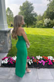 I loved this dress so much when I saw it and the green is so stunning. I wore it to a wedding and received plenty of compliments. The material is good quality and fairly thick but I was not too hot in it on a summer day. Overall highly recommend this for any wedding or event. - Sydney C.