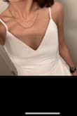 It fit well and I was able to easily wear a strapless bra underneath it. You could also completely forego wearing one but it was a little looser in the chest for me so I added one to help me fill it out. I like the cut and style but the fabric is just really not nice. I guess you get what you pay for, but I had to buy anti-static spray to be able to wear it. Also, the white color really requires nude undergarments because it's not lined in the skirt and the fabric is see-through. I did think it looked nice for what I needed it for though! - Emilyr C.