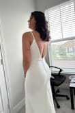 The dress is gorgeous, fits perfectly. It's very good fabric, thick and don't mark. I used without bra and was very good. The detail on the back is delicate and super beautiful. I'm in love with my dress. - Talissa A.