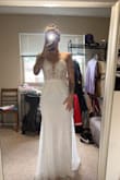 This one was my absolute favorite, and I kept it over the 10 days because I just wasn't sure. I loved it, and I almost said, "Yes", but I then couldn't stop thinking "there might be more", and I didn't want to change my mind and lose the money. I felt gorgeous in this, and there are so many things to love. The outside skirt probably will catch lint/fabric in it when it touches other people's clothing, which worried me some for pics. It was scratchy to the touch, but you don't have any of those issues on the inside as the under skirt is soft and perfect. The open back is sexy. The front is elegant and pretty. I have so many great things to say, and I thought it could be the one, but I just didn't think it would be the right fit for my fiancé's wedding day look + the venue. - Katie S.