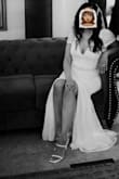 I ordered this dress for my small, simple wedding. Leading up to the wedding, I was second-guessing the dress and thought maybe I should've bought a fancier dress but I'm glad I didn't! 

The only alteration I had to make was in the front since it was a bit long. I left the back long to have a bit of a train on the back of the dress. And I sewed a pearl/diamond belt to it myself. 

Once on, it fit perfectly, I did consider ordering a XS to make it tighter to give me more of a figure but I don't think it would've fit (lol) since the Small was already a good fit. I wore a body shaper under (the ones that come up to under the boobs) and surprisingly it didn't show in the back even though it is a lower-cut dress in the back. And I also wore boob tape to give me some support. 

With the jewelry and veil, it looked beautiful! I received so many compliments on it and I felt beautiful in it!

For reference, in clothes, I usually wear a small (medium if it's not stretchy) and size 28 in jeans. - Elizabeth N.